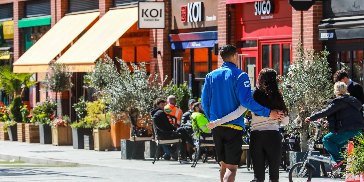 People walking past retailers on Sayer Street