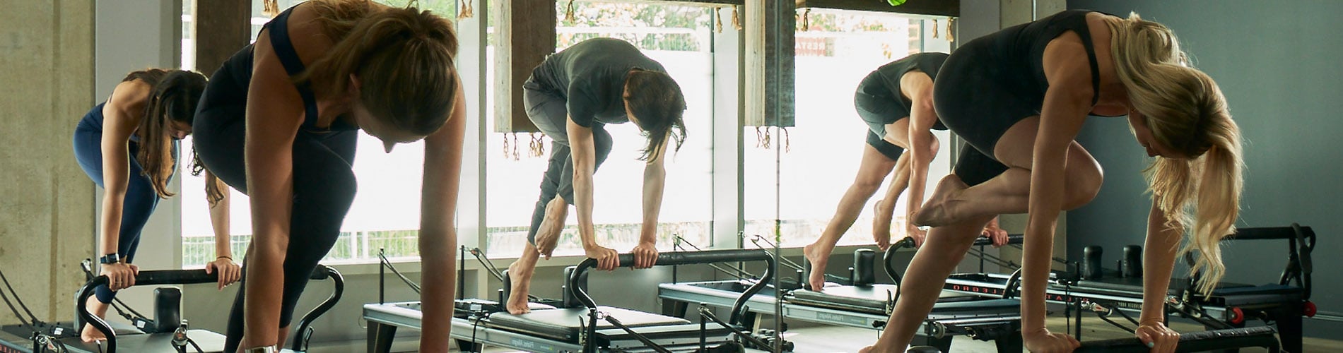 People in a gym taking part in a pilates class